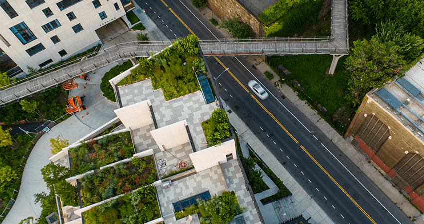 An aerial image of a road and building with a garden on top