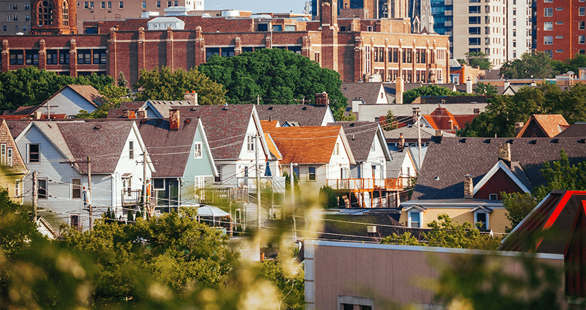 An image of the Milwaukee skyline with houses, buildings and trees