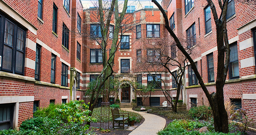 Image of a brick city apartment building with a courtyard
