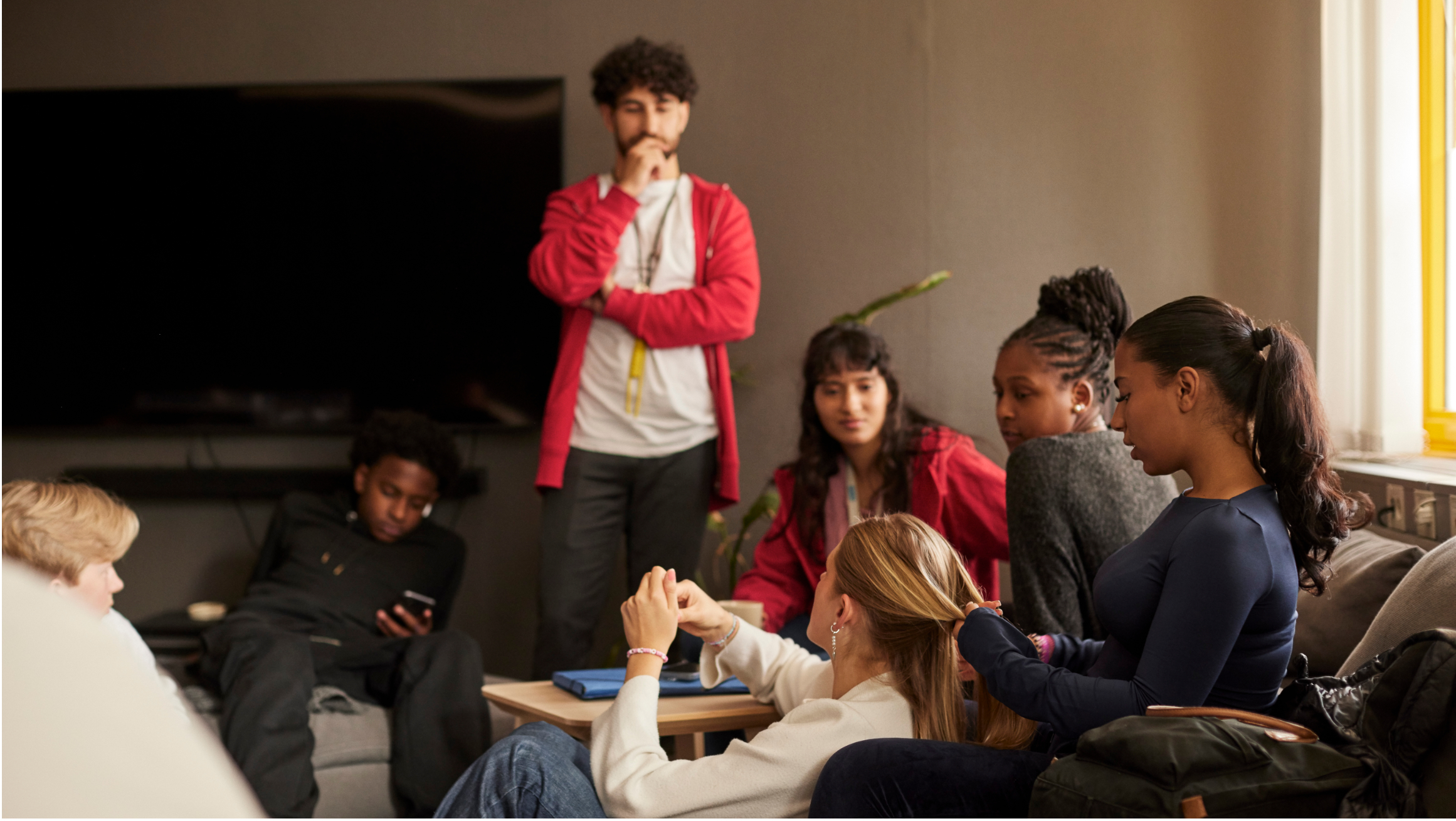 Young people gathered in a shared living space.