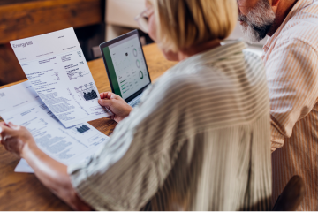 A couple looks at utility bills