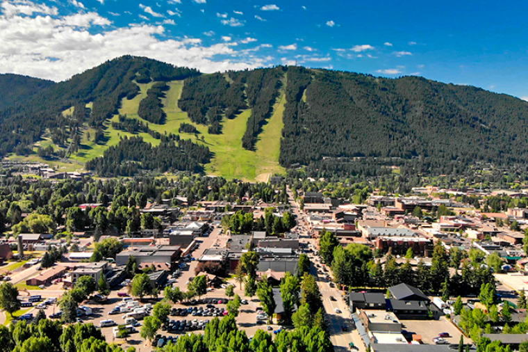 Image of a small mountain town at the bottom of a mountain on a sunny day