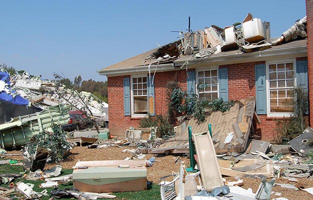 A single family home that has significant damage on the exterior. 