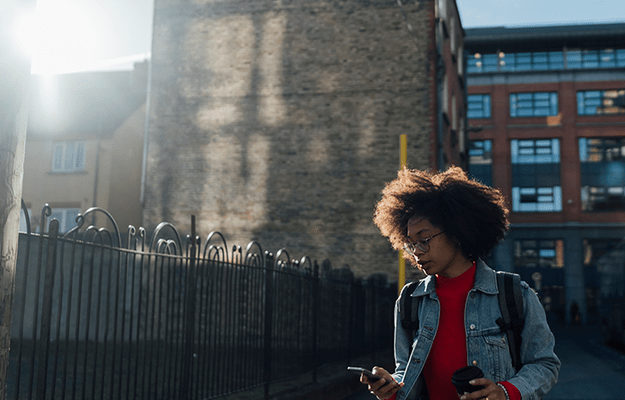 Woman walking in front of a building